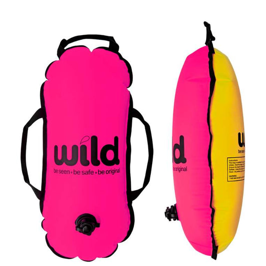 A swim tow float designed with pink and yellow colors, featuring the brand name 'WILD' on the front, with handles and an adjustable waist belt.